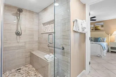 a bathroom with a shower with a glass door at Pelican Walk 401 in Panama City Beach