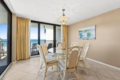 a dining room with a table and chairs at Pelican Walk 401 in Panama City Beach