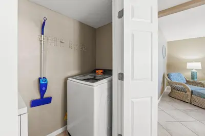 a laundry room with a washer and dryer in it at Pelican Walk 401 in Panama City Beach