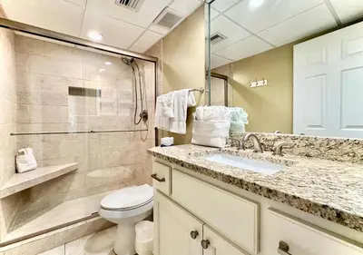 a bathroom with a toilet and a sink and a shower at Pelican Walk 102 in Panama City Beach
