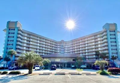 a large building with a parking lot in front of it at Pelican Walk 102 in Panama City Beach