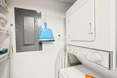 a laundry room with a washing machine and a mirror at Pelican Walk 404 in Panama City Beach