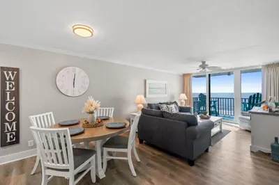 a living room with a table and a couch at Pelican Walk 403 in Panama City Beach