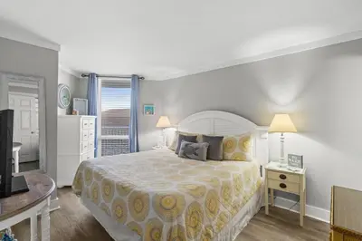 a bedroom with a large bed and a television at Pelican Walk 403 in Panama City Beach
