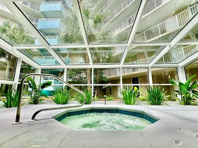a large building with a hot tub in a courtyard at Pelican Walk 209 in Panama City Beach