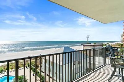 a balcony with a view of the beach and the ocean at Pelican Walk 512 in Panama City Beach