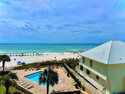 a view of a beach with a building and a swimming pool at Pelican Walk 512 in Panama City Beach