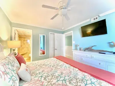 a bedroom with a bed and a ceiling fan at Pelican Walk 504 in Panama City Beach
