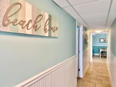 a hallway with a beach sign on the wall at Pelican Walk 504 in Panama City Beach