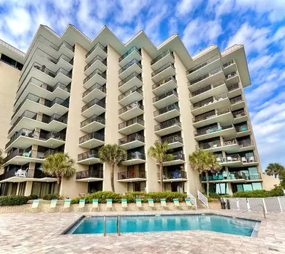 a large apartment building with a pool in front of it at Pelican Walk 504 in Panama City Beach