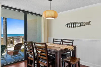 a dining room with a table and chairs at Pelican Walk 106 in Panama City Beach
