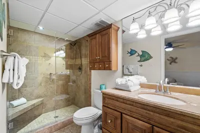 a bathroom with a shower and a toilet and a sink at Pelican Walk 106 in Panama City Beach