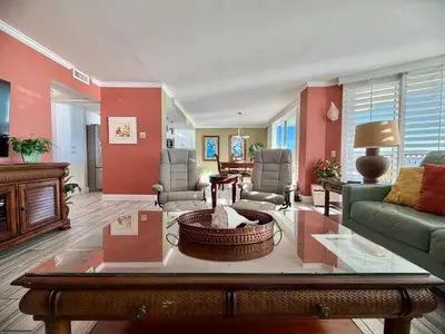 a living room with a couch and a table at Pelican Walk 506 in Panama City Beach