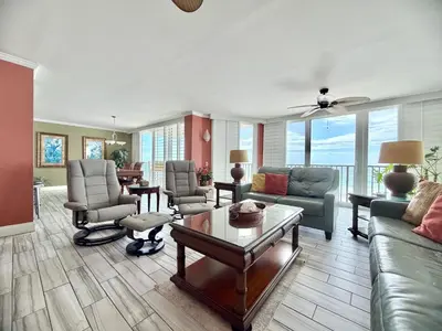 a living room with a couch and chairs and a table at Pelican Walk 506 in Panama City Beach