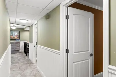 a hallway with a door leading to a kitchen at Pelican Walk 211 in Panama City Beach