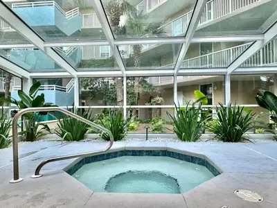 an indoor hot tub in a building with a glass ceiling at Pelican Walk 211 in Panama City Beach