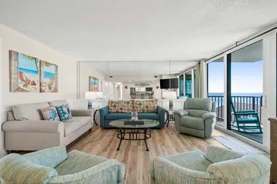 a living room with two couches and a table at Pelican Walk 601 in Panama City Beach
