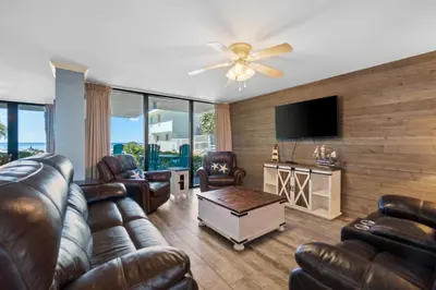 a living room with leather furniture and a flat screen tv at Pelican Walk 112 in Panama City Beach