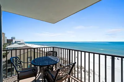 a balcony with a table and chairs and the ocean at Pelican Walk 604 in Panama City Beach