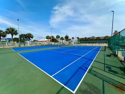 a tennis court with a blue tennis court at Pelican Walk 402 in Panama City Beach