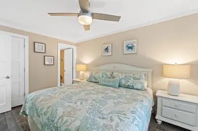 a bedroom with a bed and a ceiling fan at Pelican Walk 611 in Panama City Beach