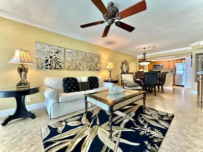 a living room with a couch and a ceiling fan at Pelican Walk 609 in Panama City Beach