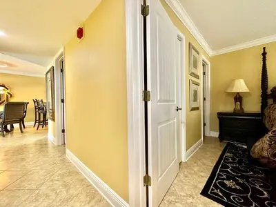 a hallway with a door and a living room at Pelican Walk 609 in Panama City Beach