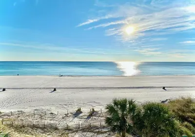 a beach with people on the sand and the ocean at Pelican Walk 408 in Panama City Beach