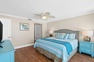 a bedroom with a bed and a ceiling fan at Pelican Walk 408 in Panama City Beach