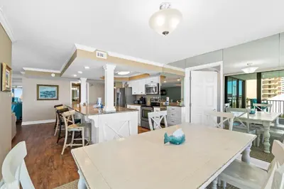 a kitchen and dining room with a table and chairs at Pelican Walk 408 in Panama City Beach