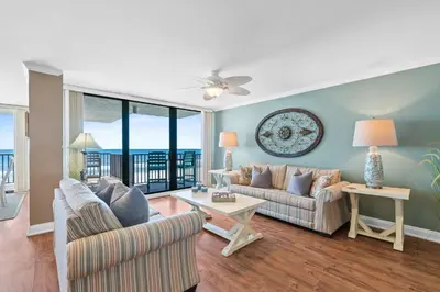a living room with two couches and a table at Pelican Walk 408 in Panama City Beach