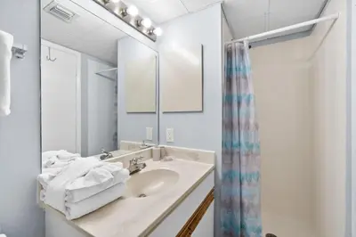 a bathroom with a sink and a mirror at Pelican Walk 902 in Panama City Beach