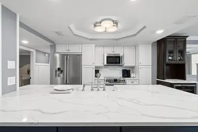 a large white kitchen with a large marble counter top at Pelican Walk 108 in Panama City Beach