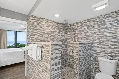 a bathroom with a brick wall at Pelican Walk 108 in Panama City Beach
