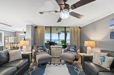a living room with couches and a ceiling fan at Pelican Walk 108 in Panama City Beach