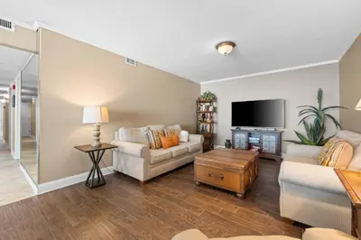 a living room with a couch and a tv at Pelican Walk 1005 in Panama City Beach
