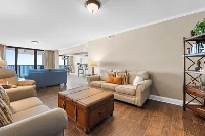 a living room with a couch and a table at Pelican Walk 1005 in Panama City Beach