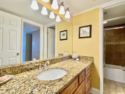 a bathroom with a sink and a large mirror at Pelican Walk 1005 in Panama City Beach