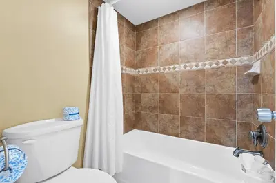 a bathroom with a toilet and a shower at Pelican Walk 1005 in Panama City Beach