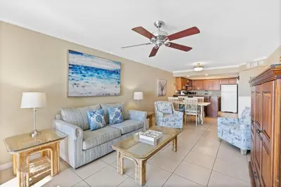 a living room with a couch and a ceiling fan at Pelican Walk 410 in Panama City Beach