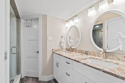 a bathroom with a sink and a mirror at Pelican Walk 501 in Panama City Beach