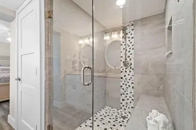 a bathroom with a shower with a glass door at Pelican Walk 501 in Panama City Beach