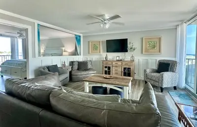 a living room with a couch and a table at Pelican Walk 501 in Panama City Beach