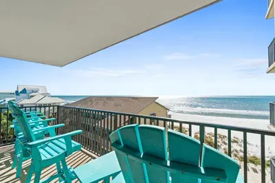 a row of chairs on a balcony overlooking the beach at Pelican Walk 501 in Panama City Beach
