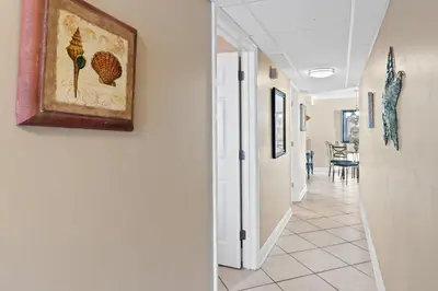 a hallway in a house with a painting on the wall at Pelican Walk 502 in Panama City Beach