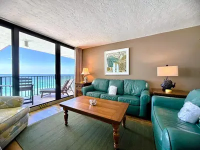 a living room with a couch and a table at Pelican Walk 1009 in Panama City Beach