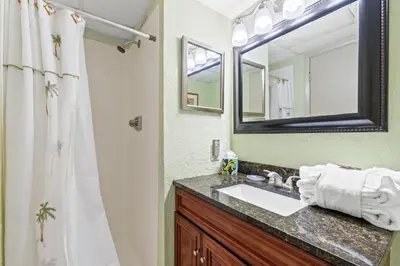 a bathroom with a sink and a mirror at Pelican Walk 1009 in Panama City Beach