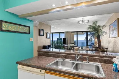 a kitchen with a sink and a view of the ocean at Pelican Walk 1009 in Panama City Beach