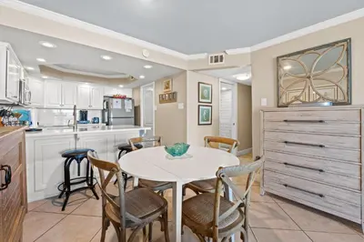 a kitchen with a table and chairs in a room at Pelican Walk 110 in Panama City Beach
