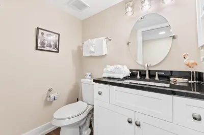 a bathroom with a white toilet and a mirror at Pelican Walk 302 in Panama City Beach
